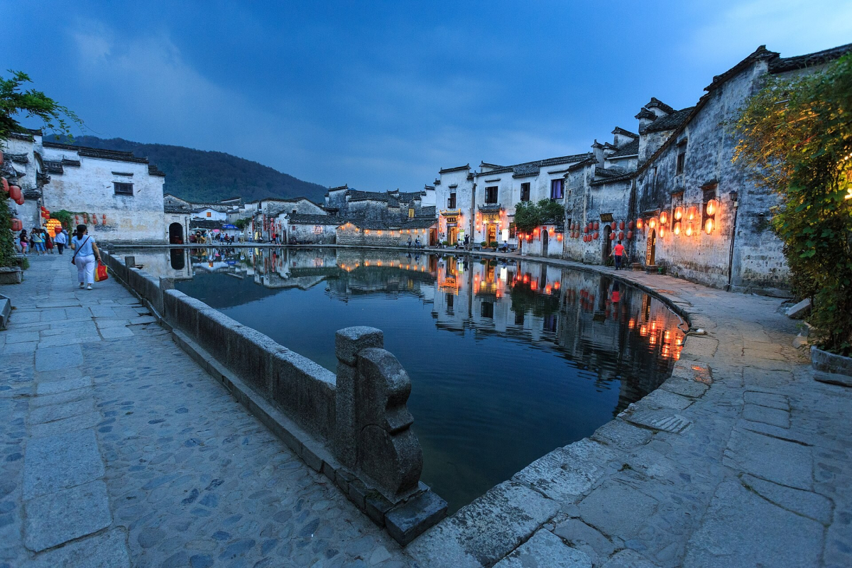 White village houses reflected in Hongcun Moon Pond at dusk White village houses reflected in Hongcun Moon Pond at dusk
