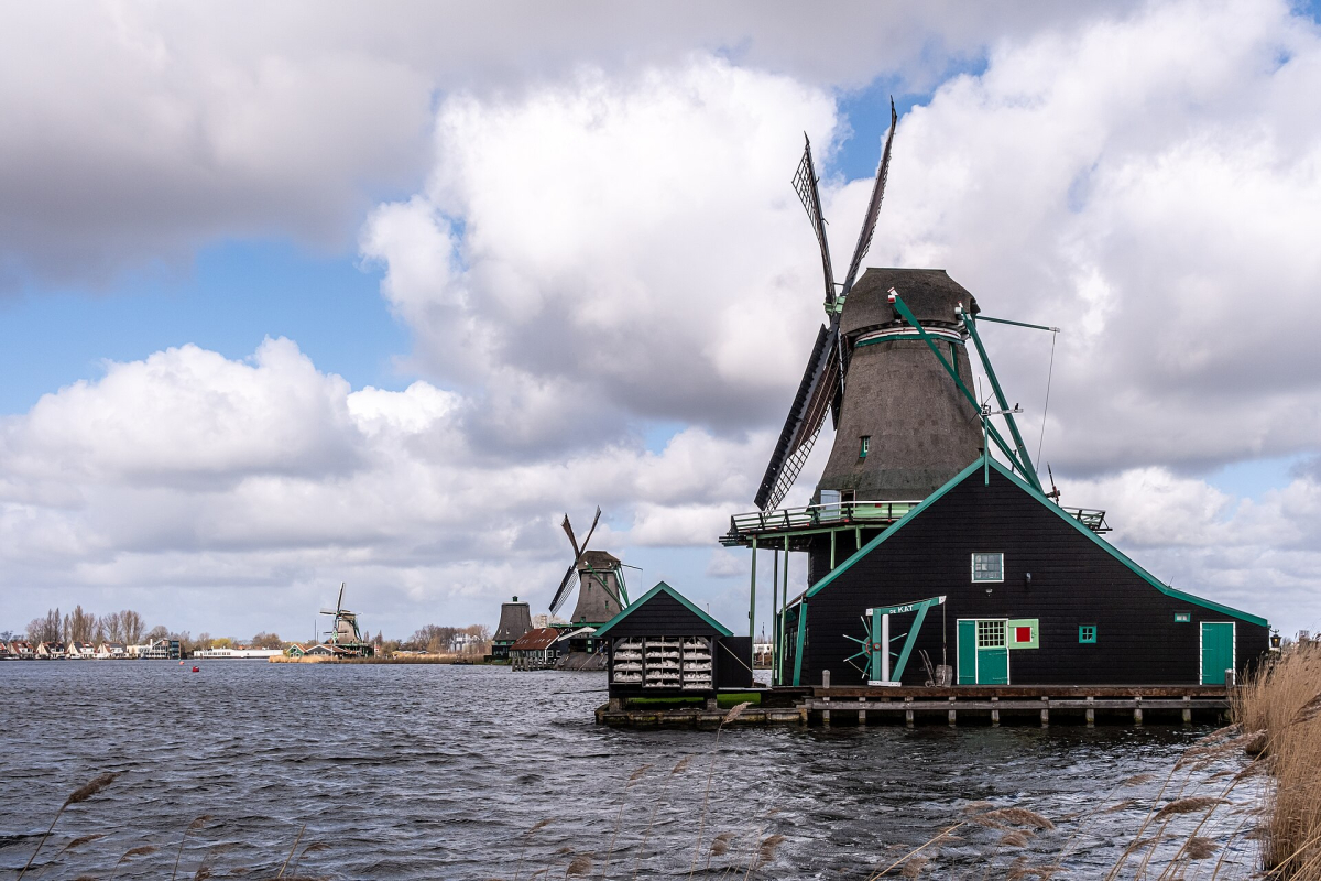 A windmill beside the water at Zaanse Schans. A windmill beside the water at Zaanse Schans.