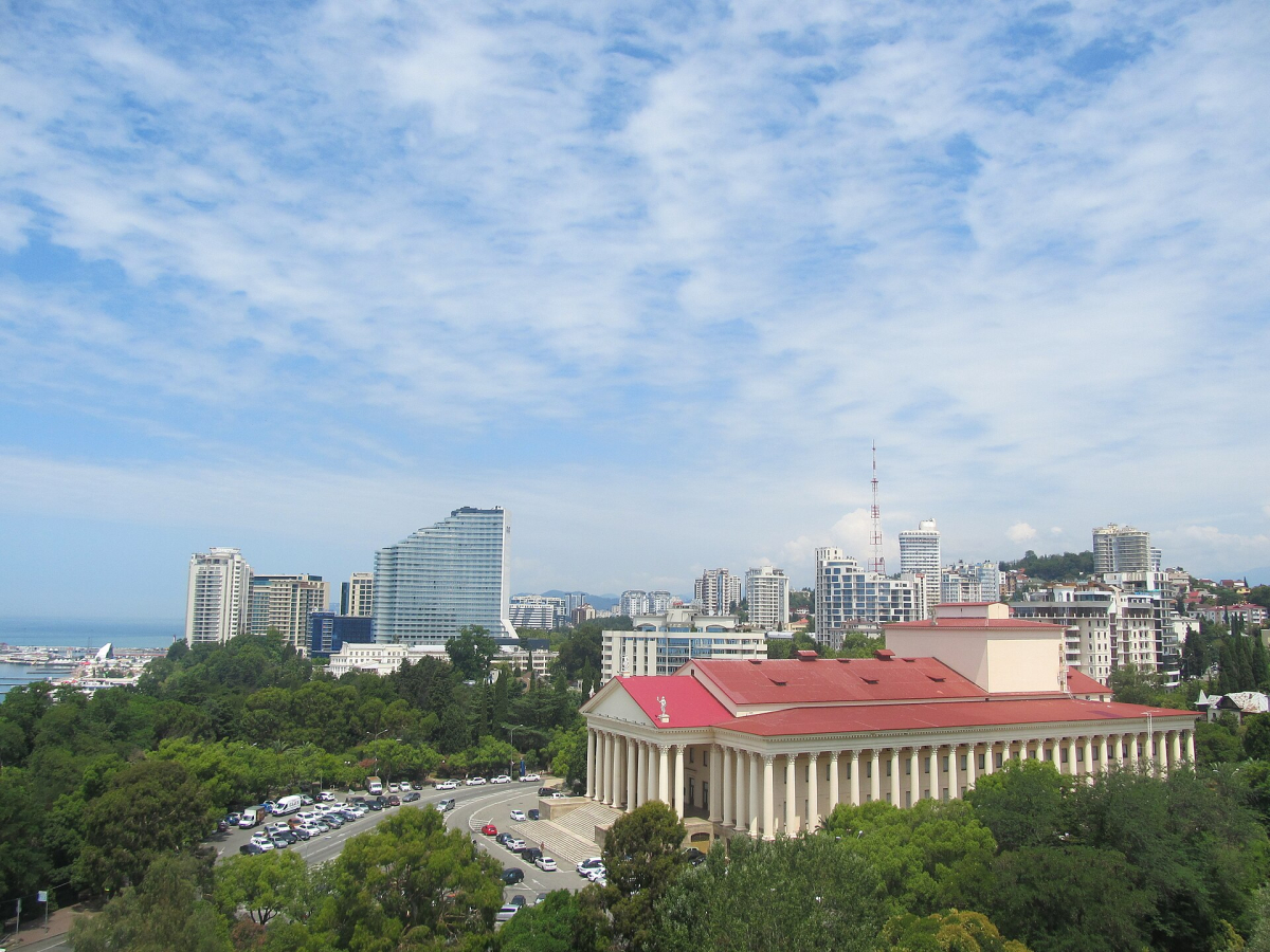 Grand Karat’s wave-fronted glass tower in the background, with Sochi’s Winter Theatre in the foreground Grand Karat’s wave-fronted glass tower in the background, with Sochi’s Winter Theatre in the foreground