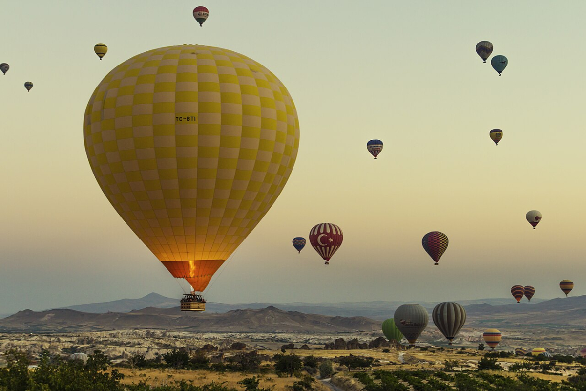 Hot-air balloons above the rocky landscape of Göreme in Cappadocia at sunrise