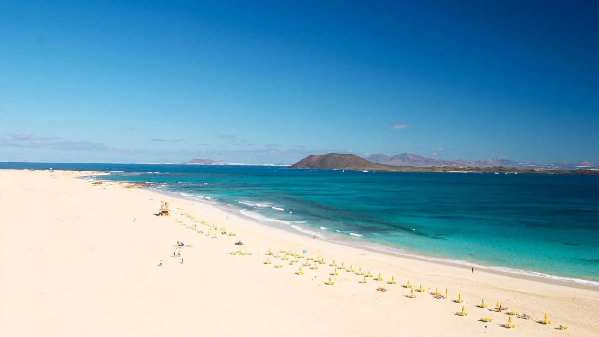 Endless white dunes of Corralejo meeting turquoise water in Fuerteventura