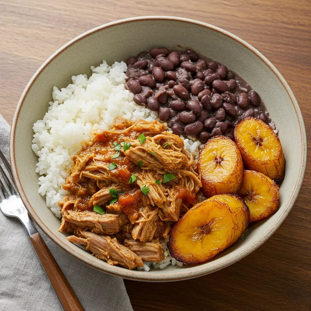 Traditional Cuban meal with rice, beans, pork, and plantains served in Havana