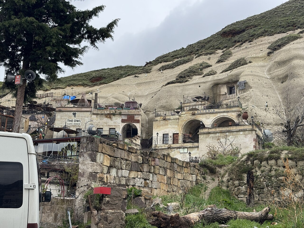 Cave hotel facades built into the hillside in Göreme