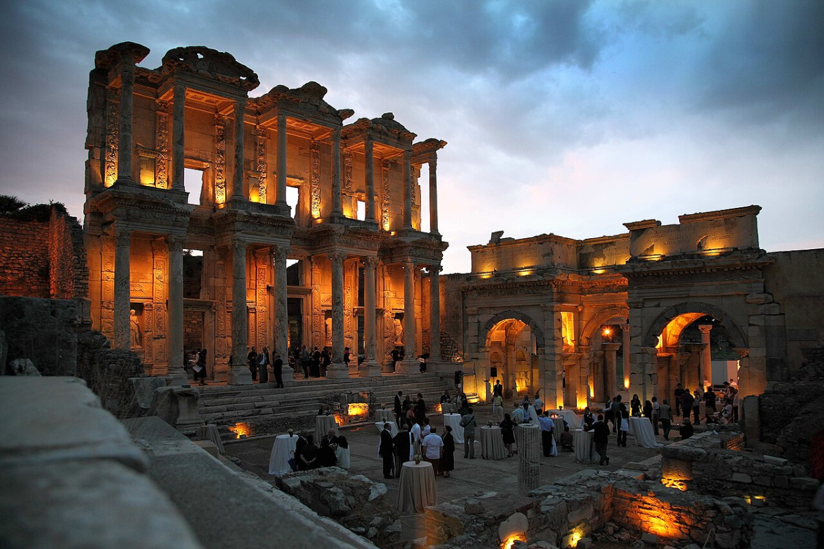 Illuminated façade of the Library of Celsus and adjacent gateway at Ephesus at dusk