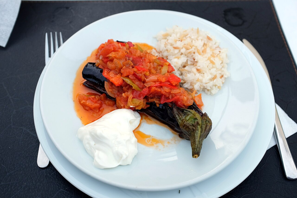 İmam bayıldı eggplant dish on a plate with rice and yogurt