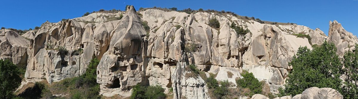 Rock-cut openings in the pale volcanic cliffs near Göreme in Cappadocia
