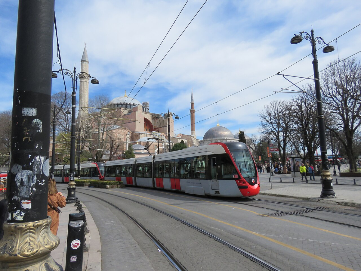A red and silver T1 tram passing Hagia Sophia in Istanbul