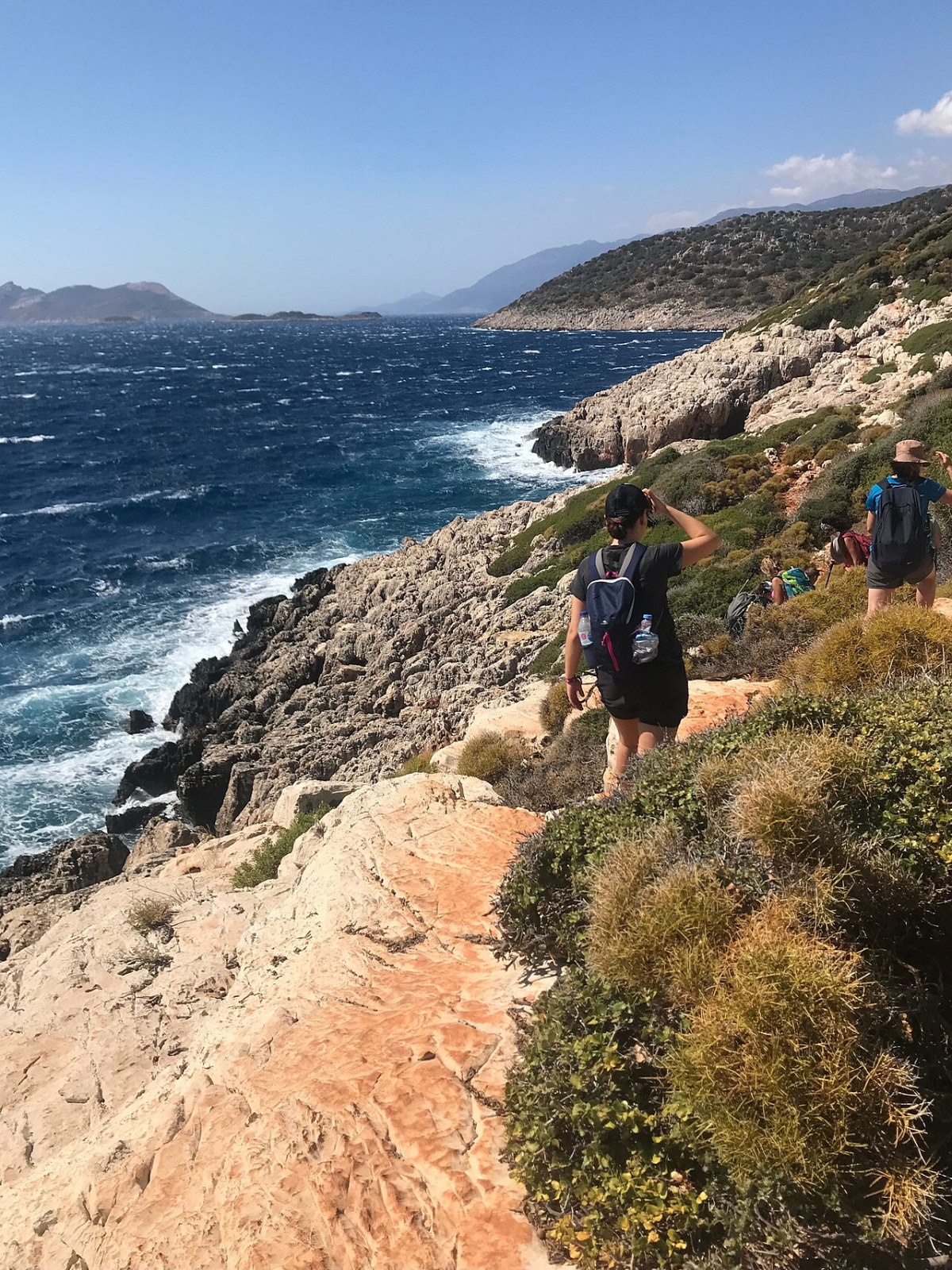 Hikers following a rocky coastal path on the Kaş section of the Lycian Way