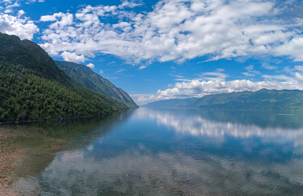 Forested mountains reflected in Lake Teletskoye Forested mountains reflected in Lake Teletskoye