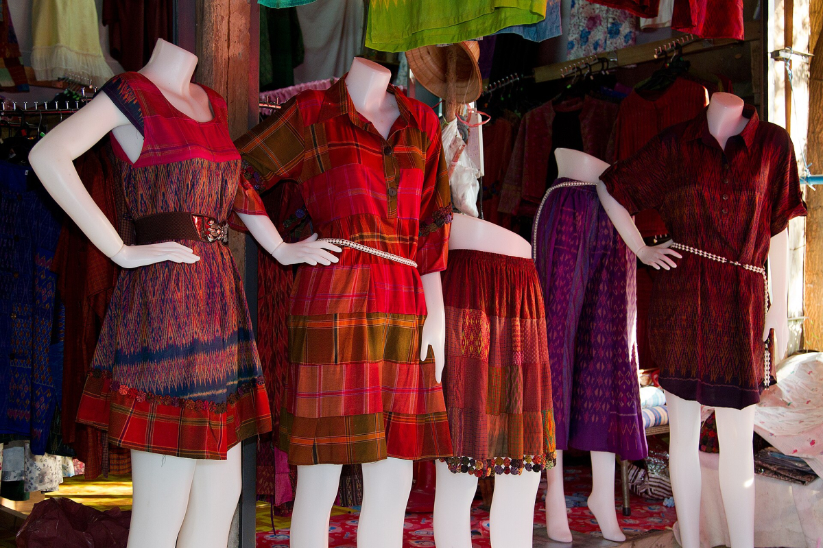 Handwoven silk dresses from Ban Tha Sawang, Surin Province. Historical product photograph; not current stock at the named Bangkok store. Handwoven Thai silk dresses from Ban Tha Sawang in Surin