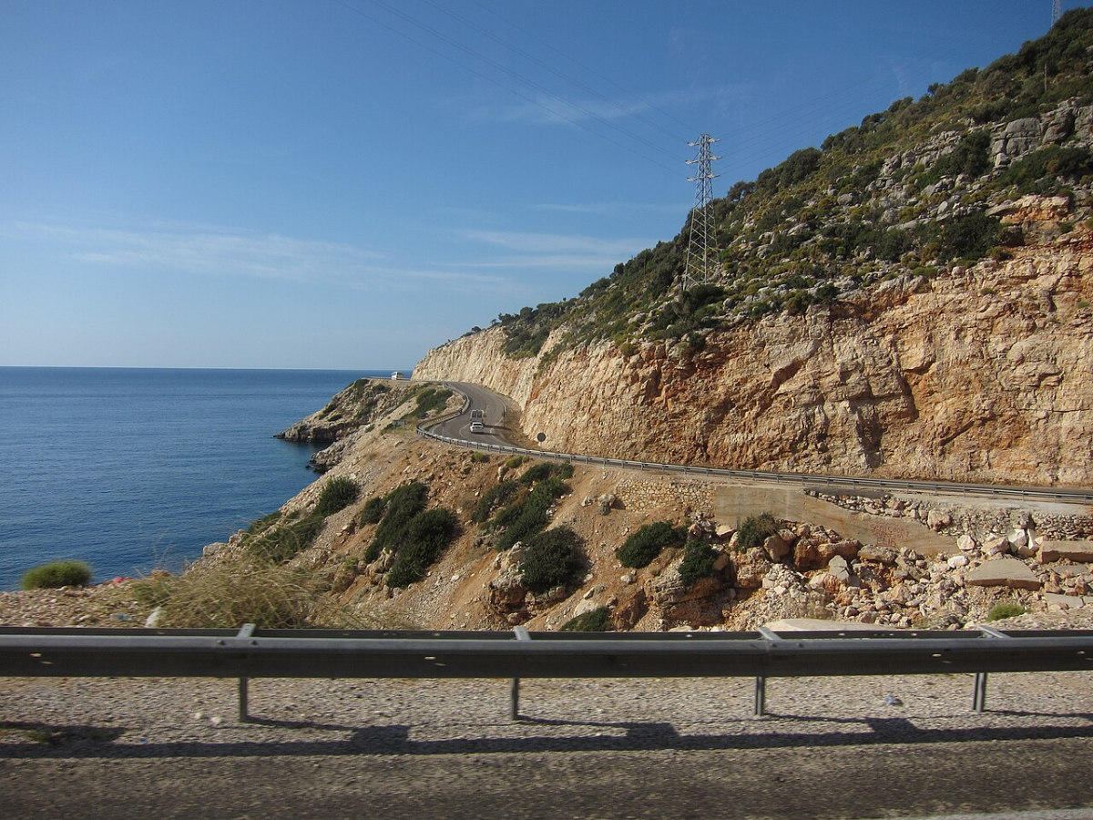The D400 coastal road winding between cliffs and the sea near Finike