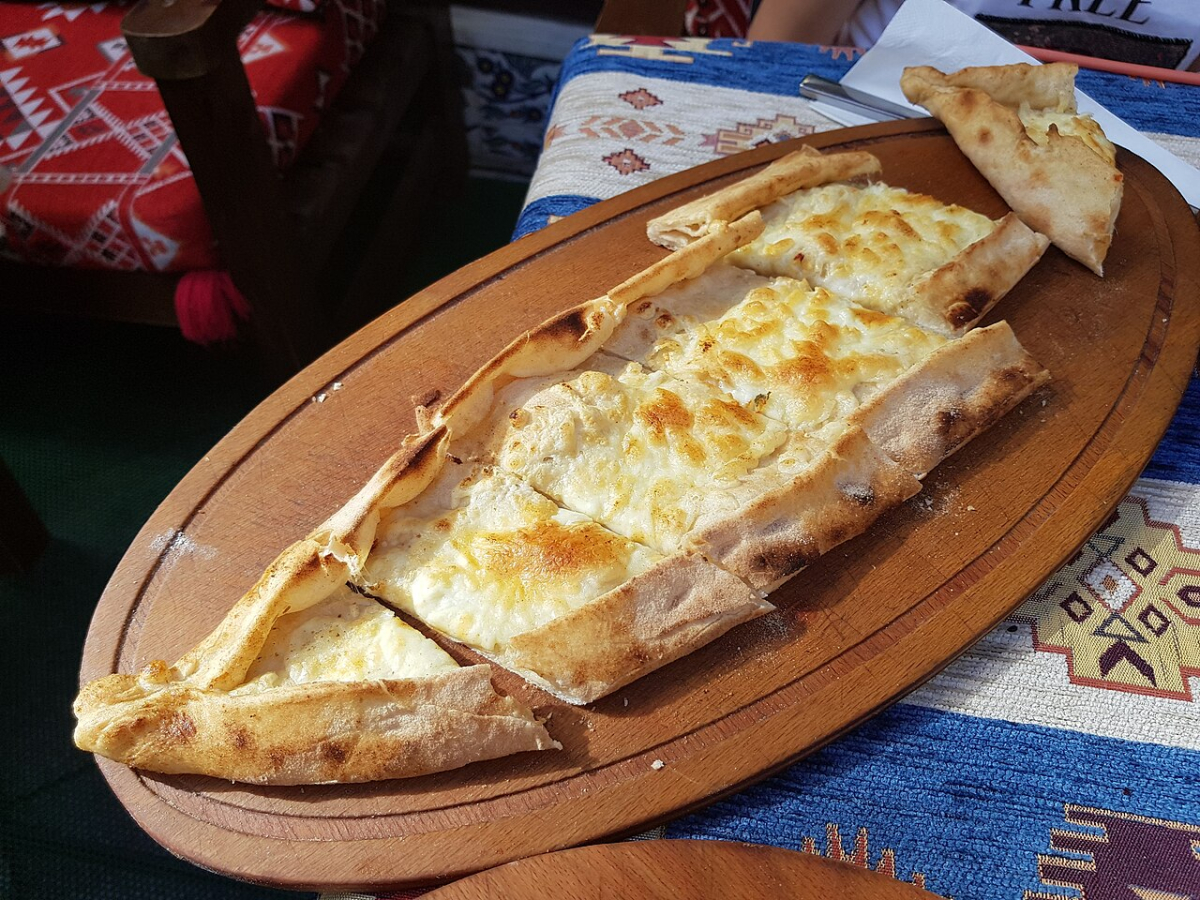 Cheese pide served on a wooden board in an Istanbul restaurant