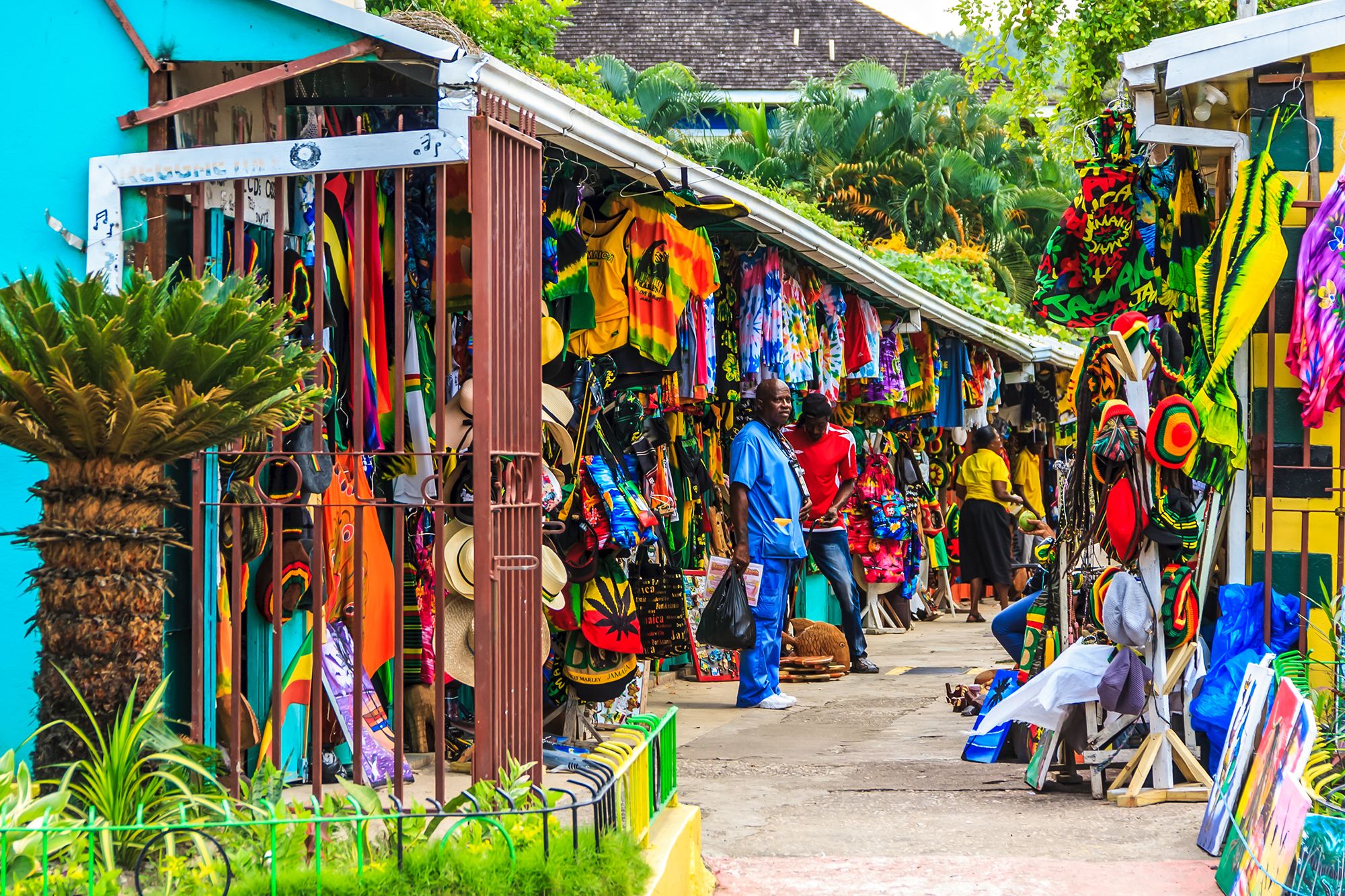 Colorful street market in Jamaica with local vendors selling handmade crafts, souvenirs and clothing