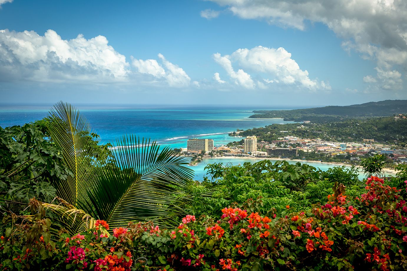 Panoramic view of Jamaica’s coastline with turquoise sea, tropical greenery and coastal towns