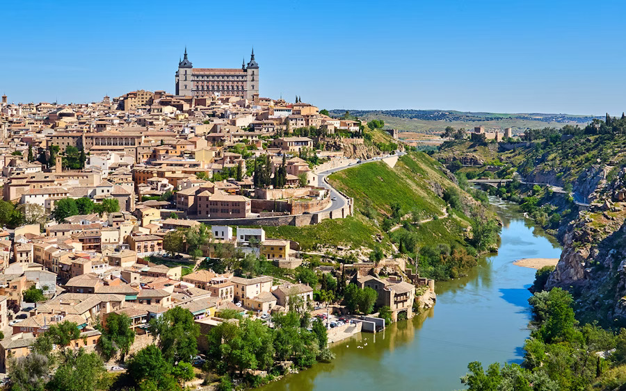 Historic hilltop town with cathedral and fortress overlooking a river valley on a day trip from Madrid