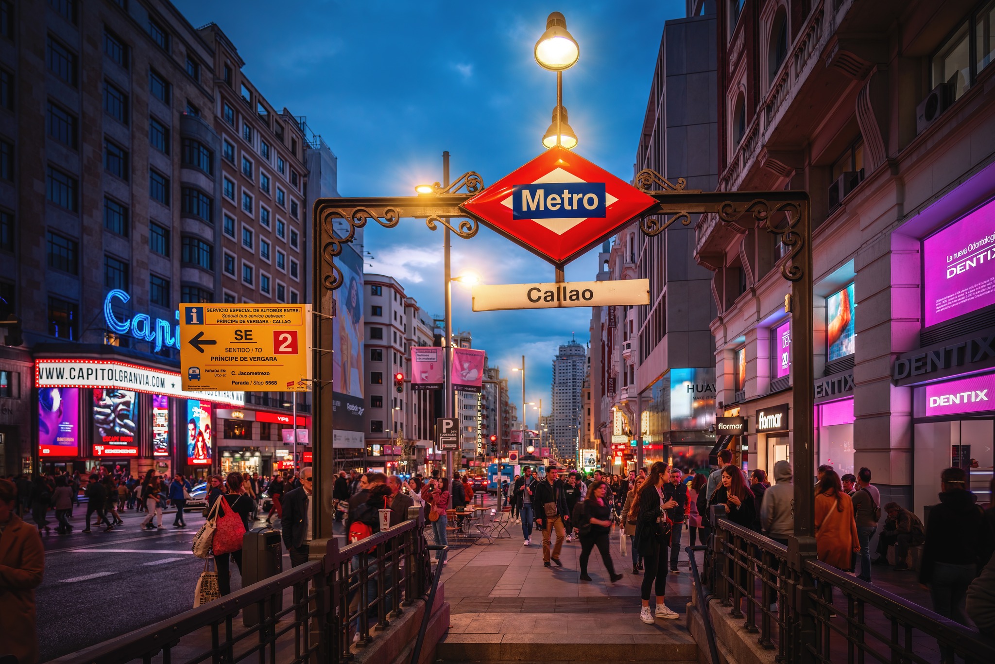 Madrid Transportation Guide Madrid Metro Callao entrance at dusk surrounded by lively city streets and commuters