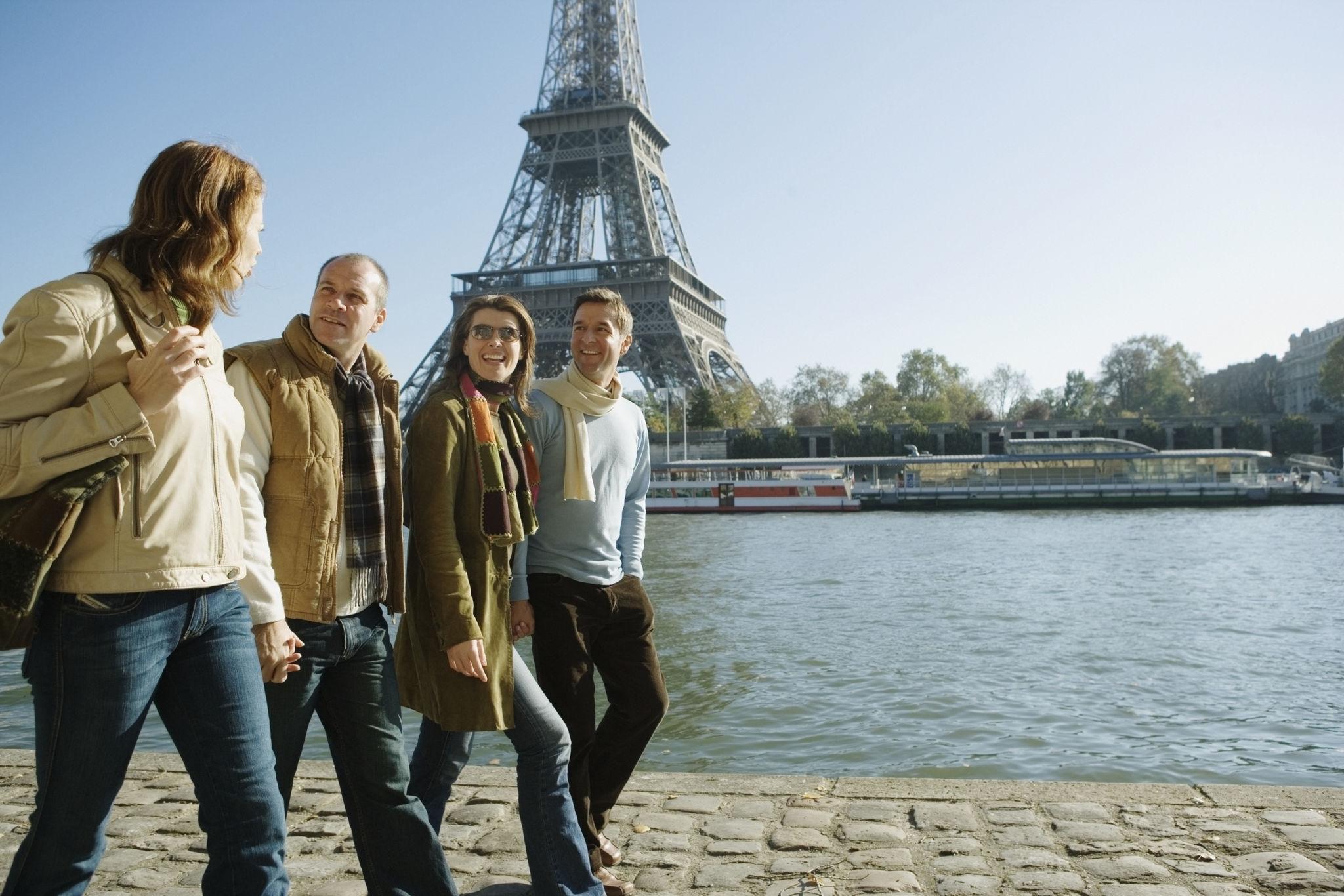 Paris Itinerary Guide Travelers exploring Paris near the Eiffel Tower during a sightseeing itinerary