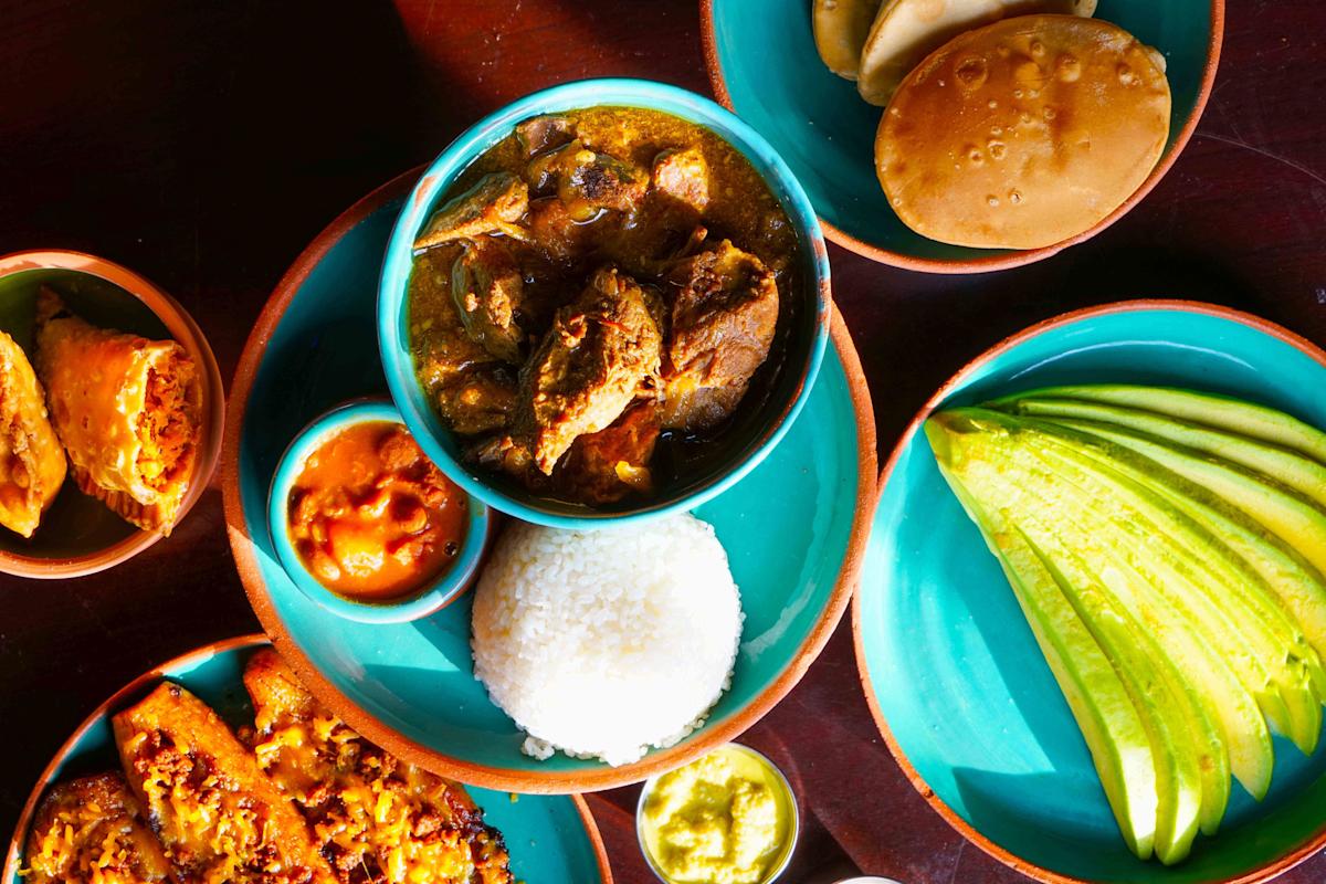 Food & Drink in Puerto Rico – Local Cuisine, Dining Culture & What to Expect Puerto Rican food spread with rice, savory dishes, sauces and fresh ingredients served in colorful bowls