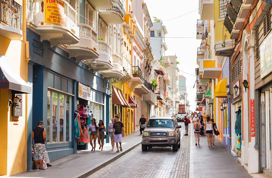 Shopping in Puerto Rico – Local Streets, Small Shops and Casual Souvenirs Colorful shopping street in Old San Juan with small local shops and people walking