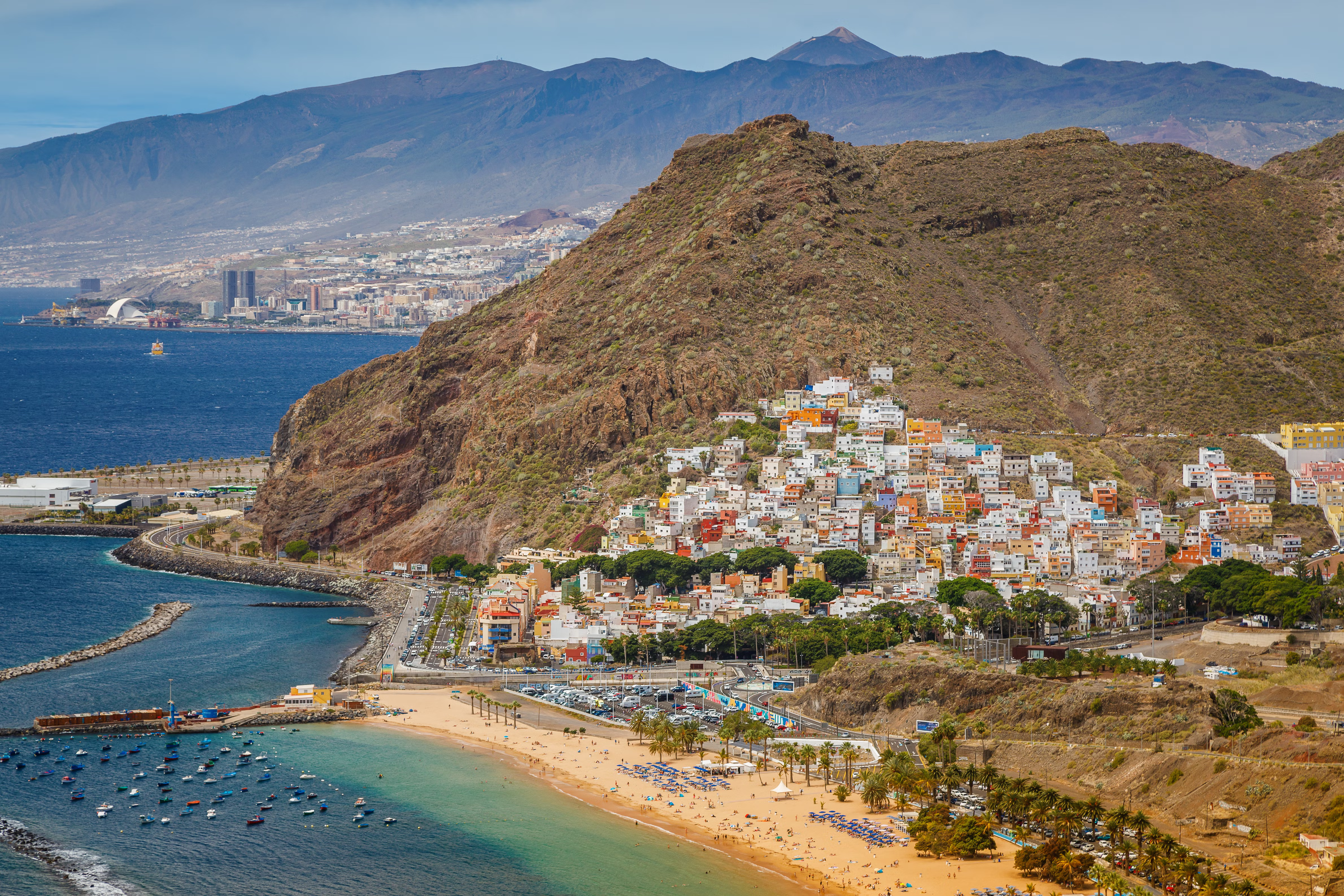 Spanish beach with mountains in the background on a clear day
