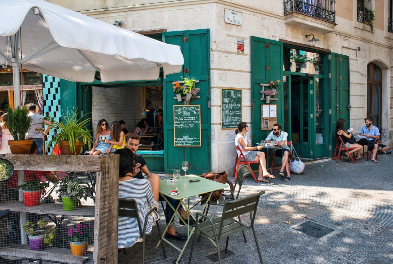 Local people enjoying an evening on a Spanish plaza with cafés and historic buildings