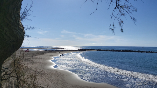 Winter sunshine over Playa de Troya beach and its breakwaters in Costa Adeje, Tenerife