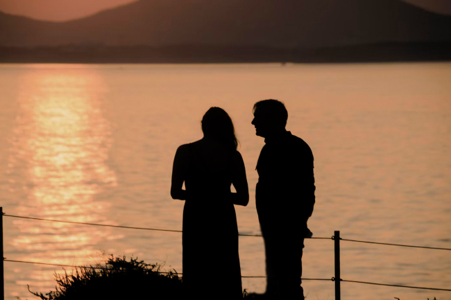 Couple watching the sunset on Naxos, one of the best Greek islands for couples
