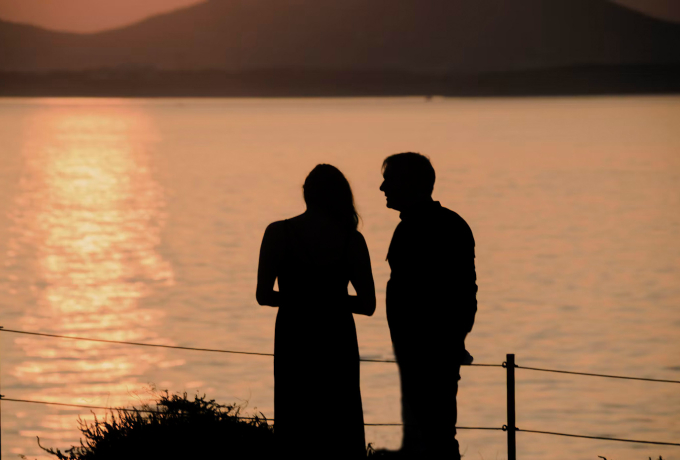 Couple watching the sunset on Naxos, one of the best Greek islands for couples