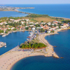 Aerial view of Fanari village port and sandy coastline in Northern Greece