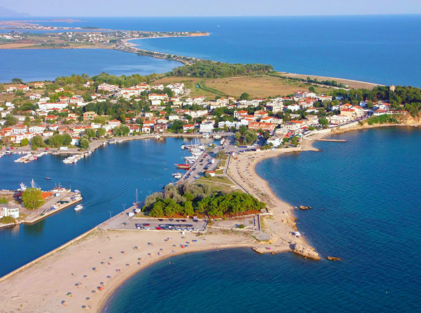 Aerial view of Fanari village port and sandy coastline in Northern Greece