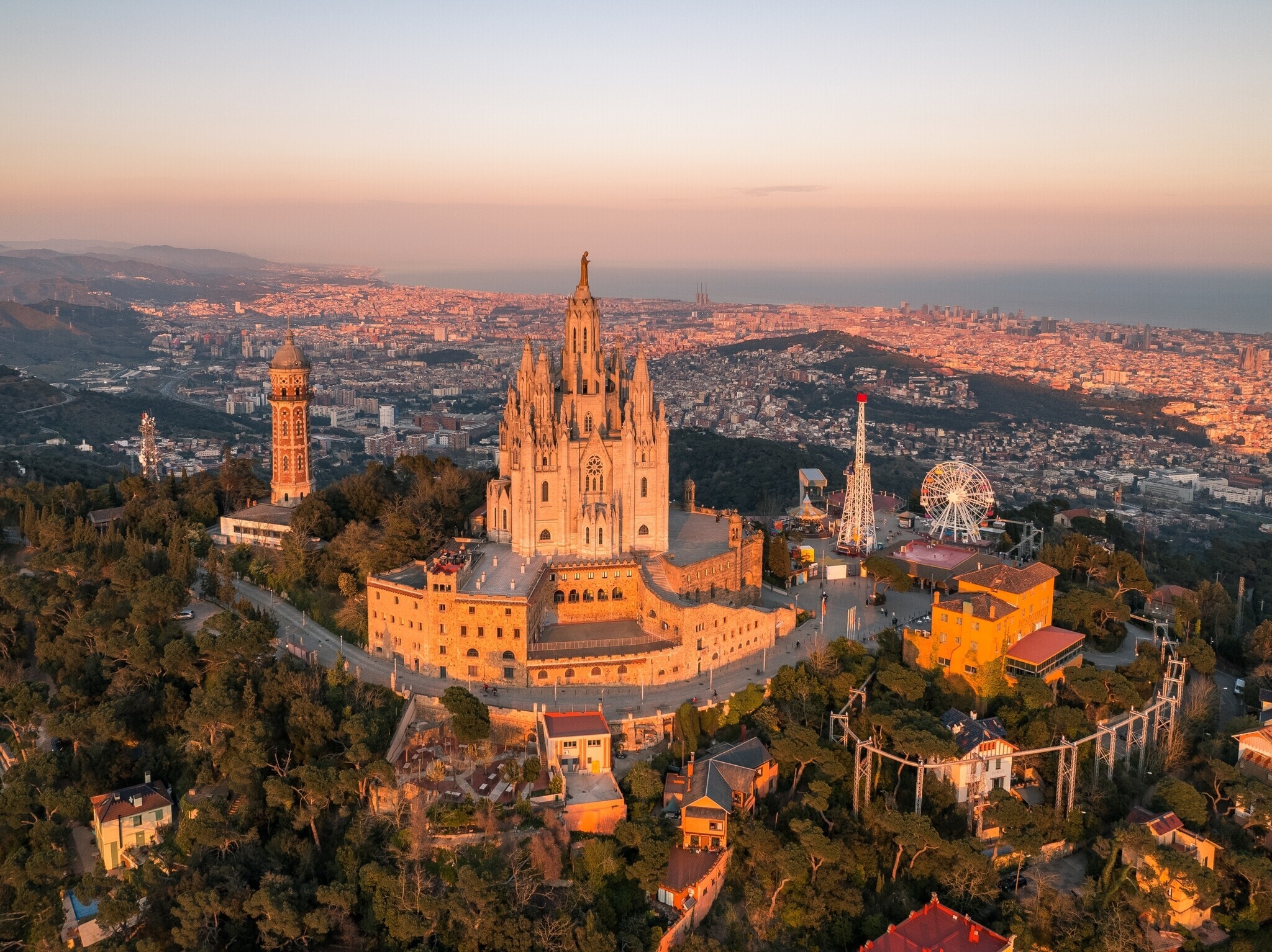 Aerial view of Tibidabo and Sagrat Cor church overlooking Barcelona city and the Mediterranean Sea