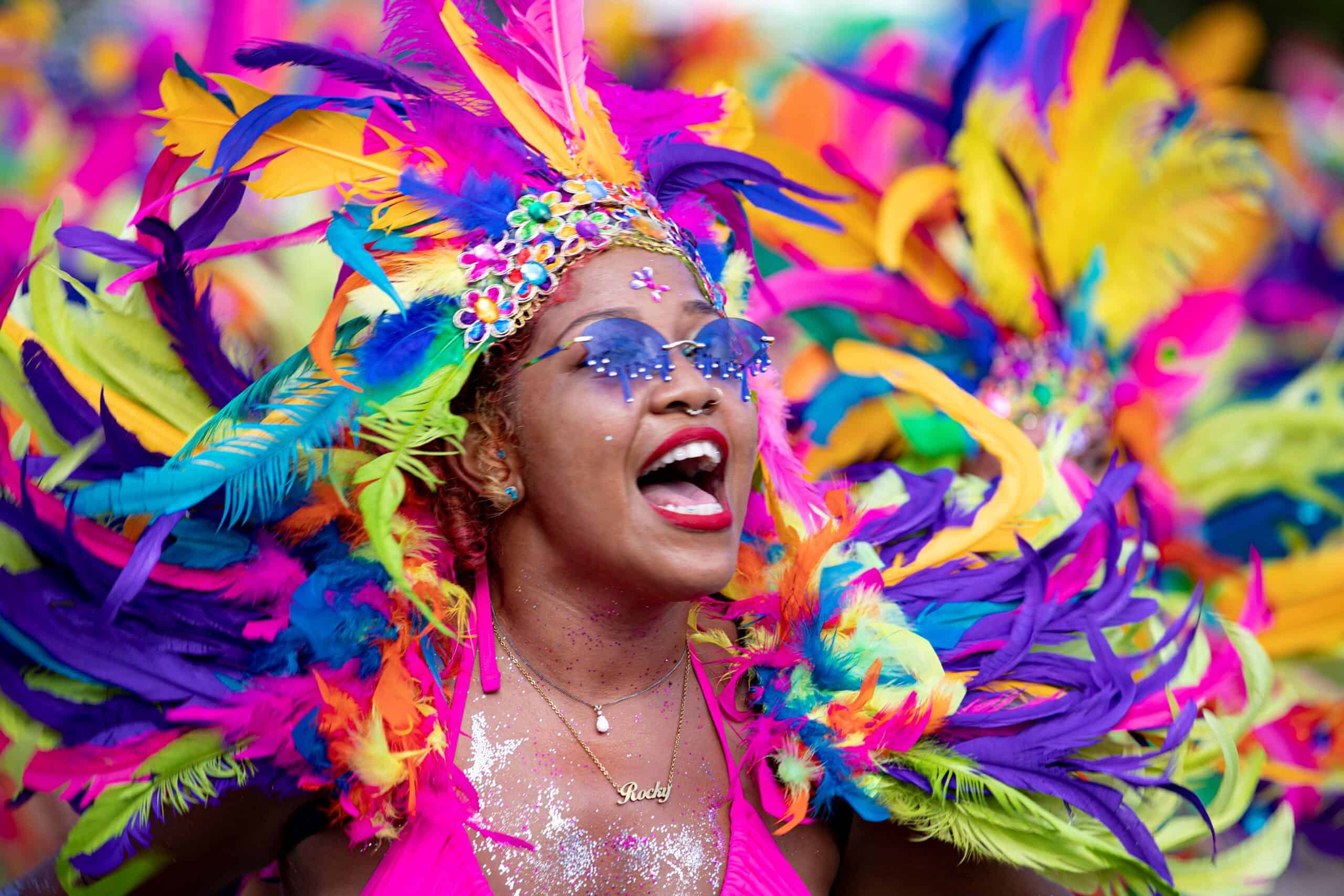 Colorful carnival performer wearing vibrant feathered costume during a Virgin Islands festival celebration